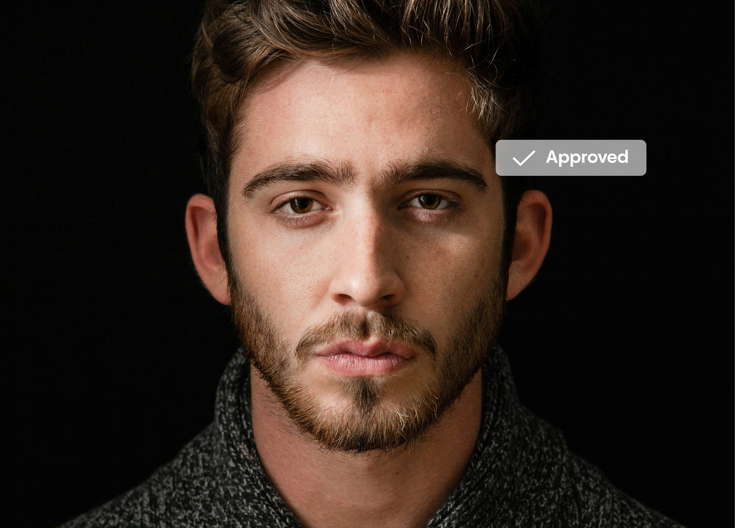 Close-up of man with beard on dark background, 'Approved' badge.