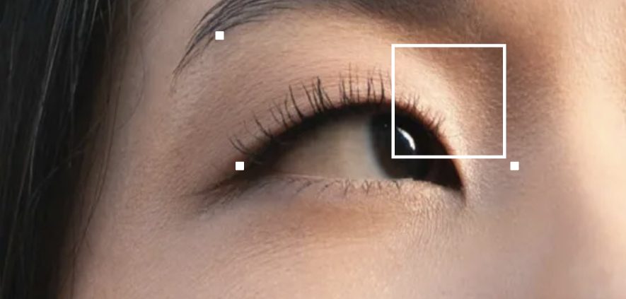Close-up of a person's eye, showing detailed eyelashes, the iris, and surrounding skin texture.